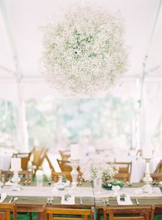 the table is set with white and pink flowers