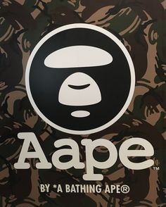 a bathing ape sign on the side of a building in front of a camouflage background