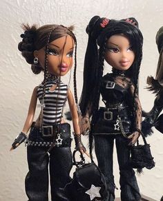 two dolls are standing next to each other