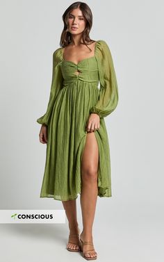 Elevate your style with our Zahara Midi Dress, a masterpiece that redefines elegance in every thread. This stunning Blouson Sleeve Cut Out Dress, in a vibrant shade of green, is more than just a piece of clothing it's a statement of empowerment and individuality designed to highlight the unique beauty of every woman. Crafted from luxurious textured woven Tencel, this eco-conscious fabric not only feels good on your skin but also aligns with your values, supporting sustainable fashion choices. Product Details: Zips detail Inner lining A-line dress Textured woven fabric V-neck Party day perfect Midi length Long sleeve Made from Tencel. Size and Fit Size S / 8 length: 115.5cm / 45.47in Material and Care Main Fabric: 75% Tencel, 25% Nylon Lining: 100% Rayon No Stretch Green Outfits, Red Sequin Dress, Basic Black Dress, Wedding Green, Neon Outfits, Bachelorette Dress, Spring Maxi Dress, Navy Bridesmaid Dresses, Blouson Sleeve