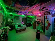 a bedroom with green and purple lights on the ceiling