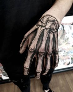 a person with a black and white tattoo on their hand