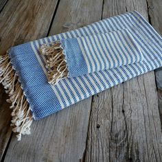 a blue and white towel laying on top of a wooden floor