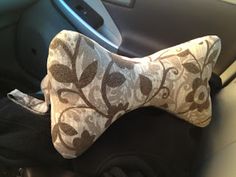 the interior of a car with a dog bone shaped pillow