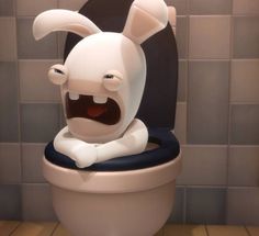 a cartoon character sitting on top of a toilet