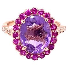 3.79 Carat Natural Amethyst Pink Sapphire Diamond Rose Gold Engagement Ring Playful yet Powerful! Its like having a piece of glittery candy on your finger! This ring has a bright Oval Cut Amethyst that weighs 3.10 Carats and is embellished with a halo of 20 Pink Sapphires that weigh 0.57 Carats as well as 12 Round Cut Diamonds along the shank that weigh 0.12 Carats. The total carat weight of the ring is 3.79 Carats. The ring is crafted in 14 Karat Rose Gold and weighs approximately 3.9 grams. The ring is a size 7 and can be re-sized at no additional charge. Rose Gold Diamond Ring Engagement, Pink Sapphire Ring, Gold Cocktail Ring, Purple Jewelry, Gold Cocktail, All Things Purple, Rose Gold Engagement, Put A Ring On It, Gold Engagement Ring