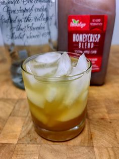 a close up of a drink on a table with ice and syrup in the background