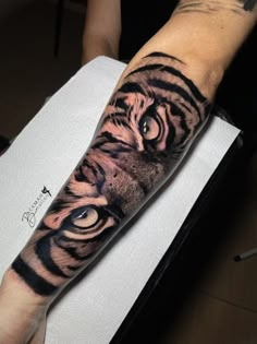 a man with a tiger tattoo on his arm