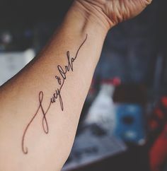 a woman's arm with a tattoo that reads, we are family