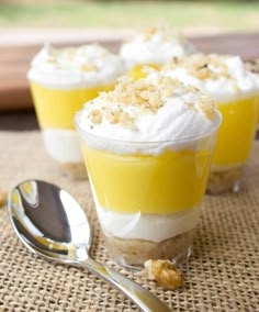 three desserts are sitting on a table with spoons