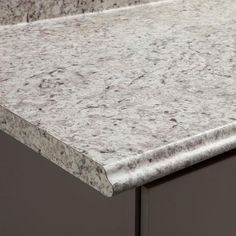 the counter top is made of granite and has two drawers on each side, with one drawer open