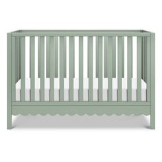 a green crib with white sheets on the top and bottom, in front of a white background