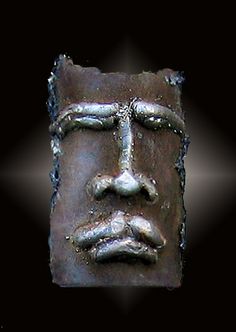 a face made out of metal on a black background