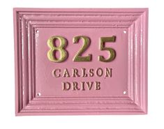 a pink and gold house number plaque with the words'825 garrison drive '