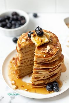 a stack of pancakes with blueberries and bananas on top