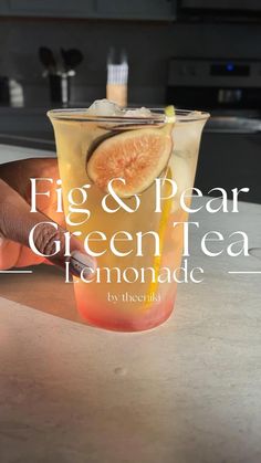 fig and pear green tea lemonade in a glass on a counter top with text overlay that reads fig & pear green tea lemonade