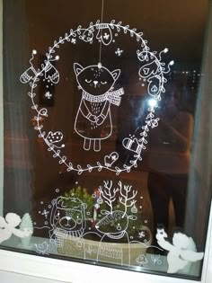 the window is decorated with an image of a cat and other animals in a wreath