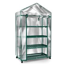 a green house with shelves and wheels on the bottom shelf, in front of a white background