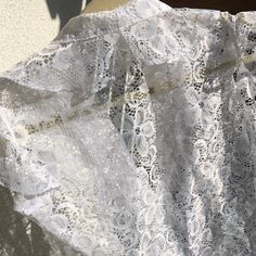 Gorgeous white lace romantic blouse. Lovely buttons! by Jürgen Michaelsen. Good vintage condition  Labelled size 38 Measurements (item lying flat on the ground, doubled for chest, waist and hips): Length on the back about 61 cm(  24.02 inches) Bust armpit to armpit  about  94 cm ( 37.01 inches) Waist about 86 cm (  33.86 inches) Arm from shoulder seam  cm (  inches) Shoulder width measured on the back about  cm (   inches) Bottom hem about 94 cm (  37.01 inches) Please note that the item is vintage and used! I always try to ship as fast as possible, processing the order normally takes up to 2 weeks , depending on my traveling schedule.  Please contact me if you have any questions about the item or shipping. Thank you for checking out my store! White Lace Top With Ruffles, Lace Tops With Scalloped Lace For Daywear, Wedding Lace Blouse With Ruffles, Lace Top With Ruffles For Daywear, White Cotton Lace Top With Lace Collar, White Cotton Lace Top With Lace Patchwork, Elegant White Blouse With Scalloped Lace, Feminine White Cotton Lace Top, White Cotton Lace Top With Lace Trim