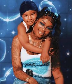 a woman holding a child in front of a blue background with stars and circles on it