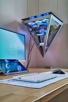 a desk with a computer, keyboard and mouse on it next to a kite shaped lamp