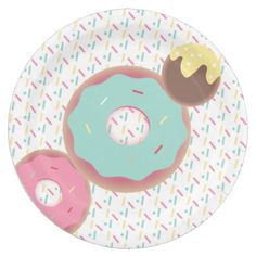 two donuts on a paper plate with sprinkles