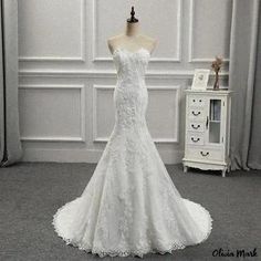 a white wedding dress on display in a room