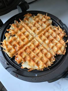 a waffle sitting on top of a black pan