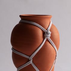 a clay vase with rope wrapped around it