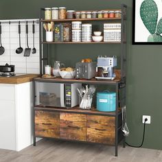 a kitchen with green walls and wooden shelves