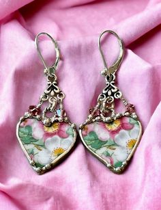 These charming earrings were made from pink and green apple blossoms Crown Staffordshire, Maytime, broken china from and recycled into earrings.  They were decoratively soldered with a lead free silver alloy and hang from a sterling silver twisted jump rings and a sterling silver chandelier. There are two Swarovski violet crystals that dangle from the chandelier. The earrings dangle 1 1/2 inches long.  The china heart measures 7/8 inch wide and 7/8 inches in length.  Your jewelry will come in a China Earrings, Soldered Jewelry, Apple Blossoms, Broken China Jewelry, Silver Chandelier, Soldering Jewelry, China Jewelry, Broken China, Bird Pendant