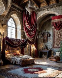 a bedroom with red drapes hanging from the ceiling and a large bed in it