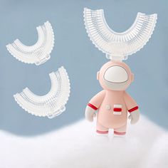 a small toy is standing next to some fake teeth on a blue background with white clouds