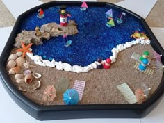 there is a sand tray with toys on it