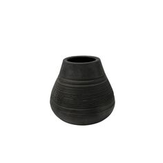 a black vase sitting on top of a white surface