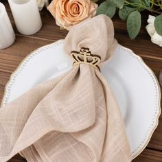 a table setting with napkins and flowers