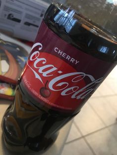 a bottle of coca cola sitting on top of a counter