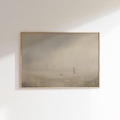 a painting hanging on the wall above a bed in a room with white walls and flooring