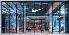 the inside of a nike store with glass doors