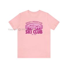 Introducing our exclusive Rocky Mountain Ski Club Graphic T-Shirt - the perfect fusion of comfort and style for winter lovers, skiing enthusiasts, and those who appreciate trendy apparel. Available in a variety of 10 vibrant colors, this T-shirt features a unique design on the front, showcasing the iconic Rocky Mountain ski club emblem, accompanied by a graphic of ski goggles and a stunning mountain landscape. Whether you're gearing up for a day on the slopes, embarking on an adventure, or simpl Sporty Logo Print T-shirt For Outdoor Activities, Sporty T-shirt With Logo For Outdoor Activities, Sporty Pink Tops For Outdoor Activities, Pink Graphic Print Top For Outdoor, Sporty Graphic Print Winter T-shirt, Sporty Graphic Print T-shirt For Winter, Sporty Top For Ski Season, Sporty Tops For Ski Season, Casual Graphic Print Tops For Winter Sports