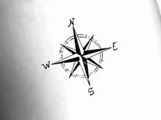 a black and white photo of a compass