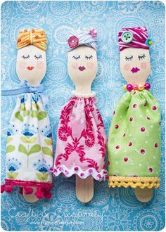 three cloth dolls are sitting next to each other