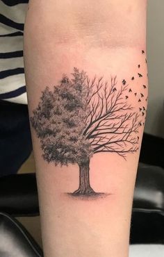 a black and white tree with birds flying around it's branches on the leg