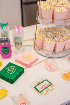 a table topped with lots of cakes and cupcakes