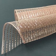 a roll of wire mesh on top of a black surface