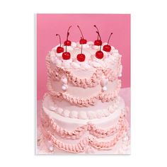 a three tiered cake with cherries on top and pink icing, against a pink background