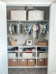 an organized closet with baskets and clothes hanging on the wall, including baby's shoes