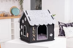 a black and white dog house sitting on top of a table