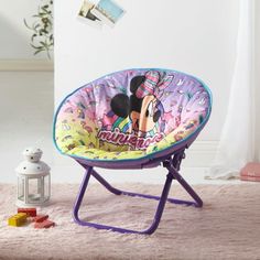 a child's mickey mouse chair on a pink rug in front of a white wall