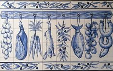 blue and white tiles with different types of food hanging on the side of each tile